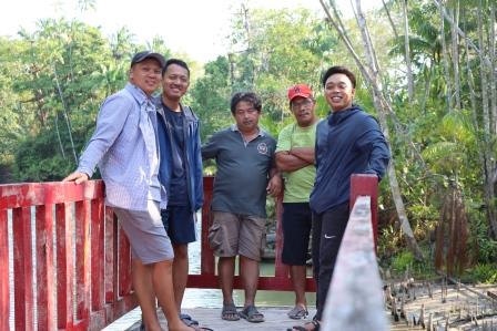 Dendi, Gede, Pak Adam, Pak Milson, and Engga on a bridge in the Bak Blau lake area