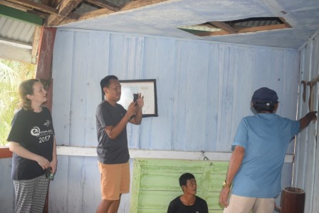 Charlotte and Gede with Datuk Ishar Timius Kaitora (the head of the Kaitora clan, in light blue shirt with cap) inside the traditional house of Kaitora clan, gathering pictures of the Enggano cultural tools